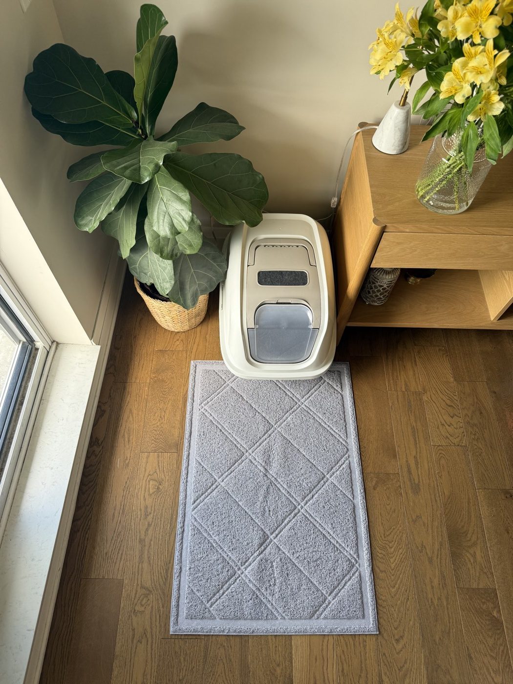 Grey litter mat fully laid out in front of the litter box